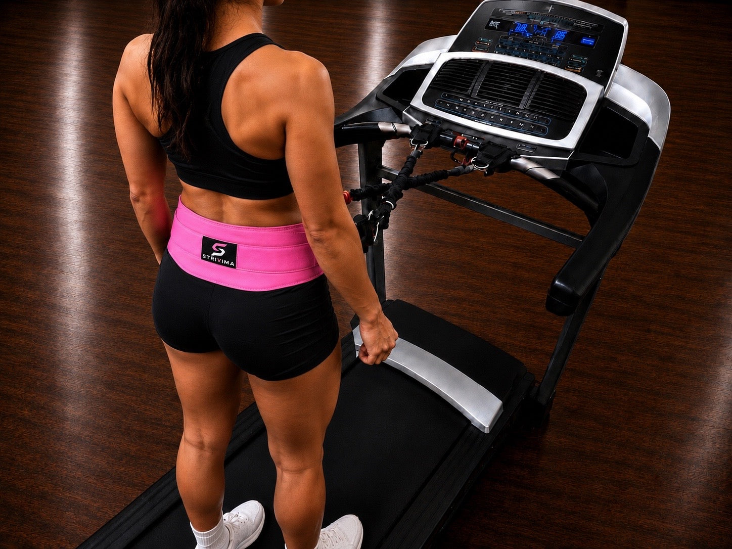 Person wearing the Stable Stepper Hottie Pink treadmill support belt while walking on a treadmill.
